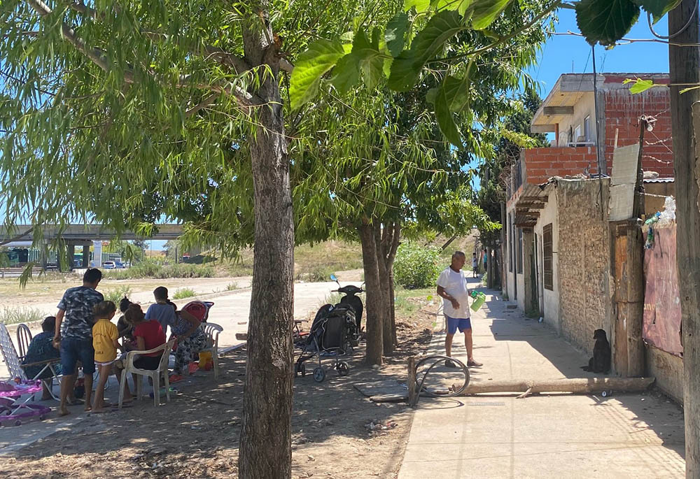 A family gathers outside their home in Villa Hidalgo, Buenos Aires, Argentina, on a late summer morning in January.