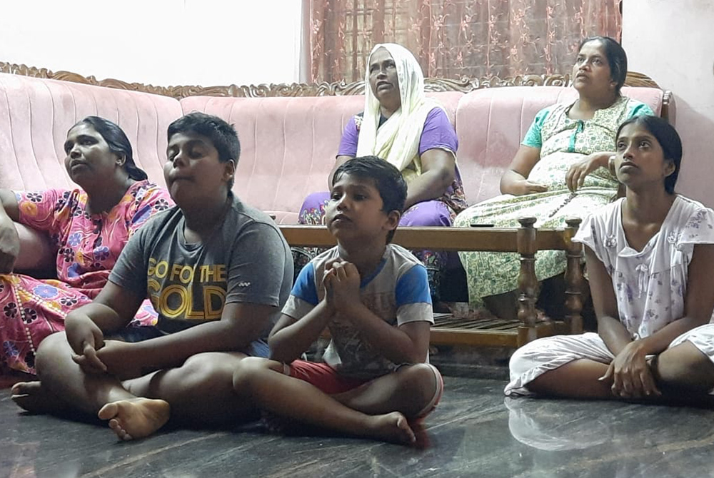 A family prays during a Home Mission visit, an intercongregational project in the Latin Archdiocese of Trivandrum. (Courtesy of Felcy Mangalath) A family prays during a Home Mission visit, an intercongregational project in the Latin Archdiocese of Trivandrum. (Courtesy of Felcy Mangalath)