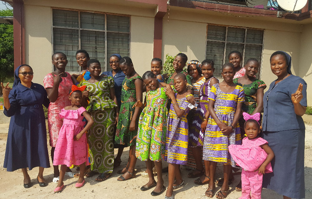 Sr. Catherine Eking (left), head of the St. Louise Community of the Daughters of Charity Sisters in Kumasi, Ghana, and Sr. Victoria Anamuni (right) pose with children of the Safe-Child Advocacy humanitarian organization. (Damian Avevor)