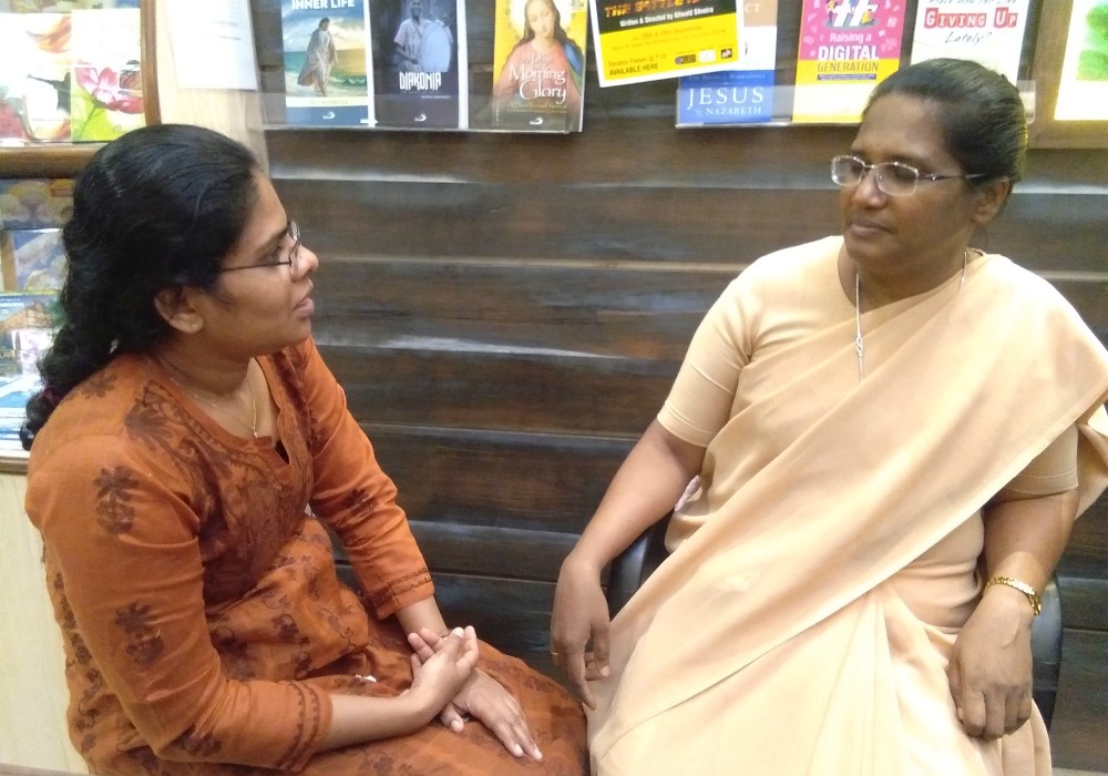 Daughters of St. Paul Sr. Nancy D'Souza listens to Rajita Rajan, a professor and lawyer. (Lissy Maruthanakuzhy)