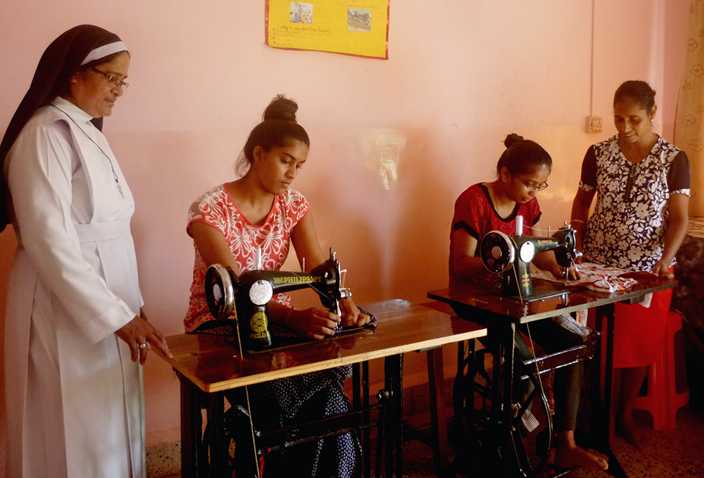 Sr. Lourenca Marques, a member of the Congregation of the Sisters of Holy Family of Nazareth, observes training in stitching with teacher Mary Fernandes (far right) at Asha Sadan at Baina in the western Indian state of Goa. (Lissy Maruthanakuzhy)