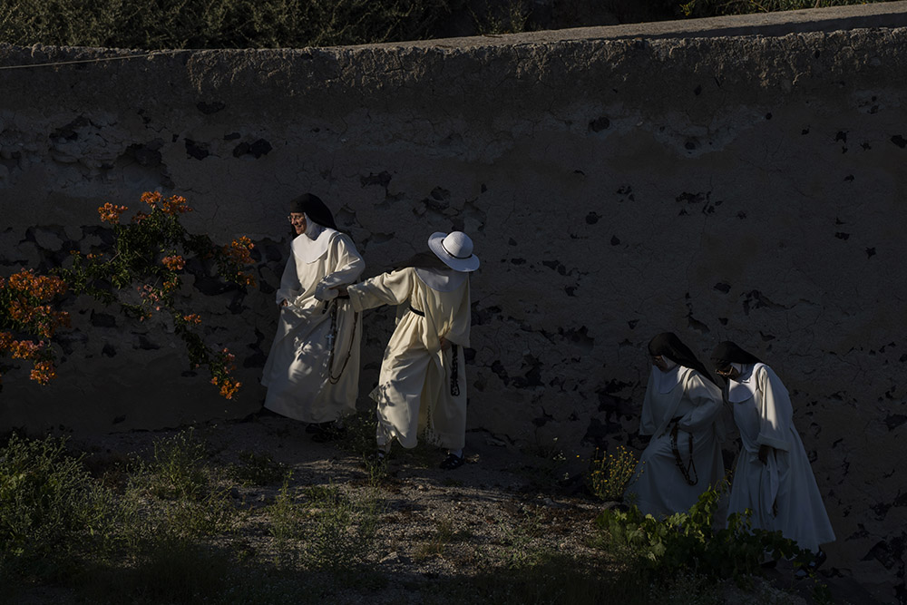From left to right, Sister María Flor, Sister María de la Trinidad, Sister María de Jesús and Sister María Teresa walk in the garden of the Catholic Monastery of St. Catherine on the Greek island of Santorini June 15. (AP/Petros Giannakouris)
