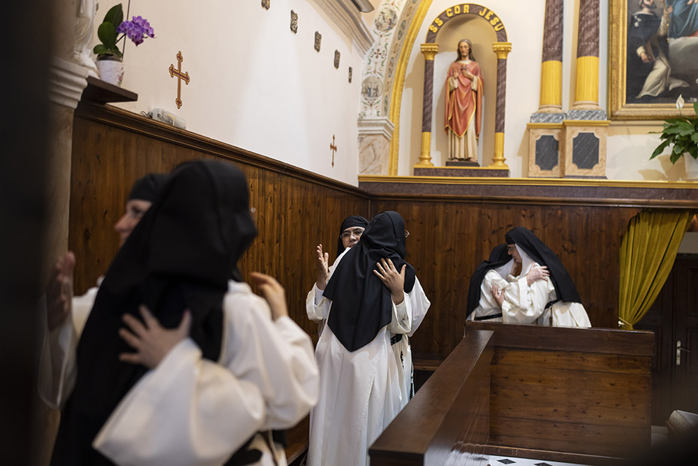 Nuns hug during the sign of peace at daily Mass in the Catholic Monastery of St. Catherine on the Greek island of Santorini June 14. (AP/Petros Giannakouris)
