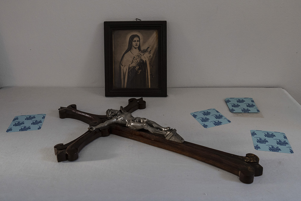 A wooden crucifix and a picture of St. Thérèse of Lisieux lie on a table inside the Dormition of the Virgin Mary Catholic Church on the Greek island of Santorini June 15. (AP/Petros Giannakouris)