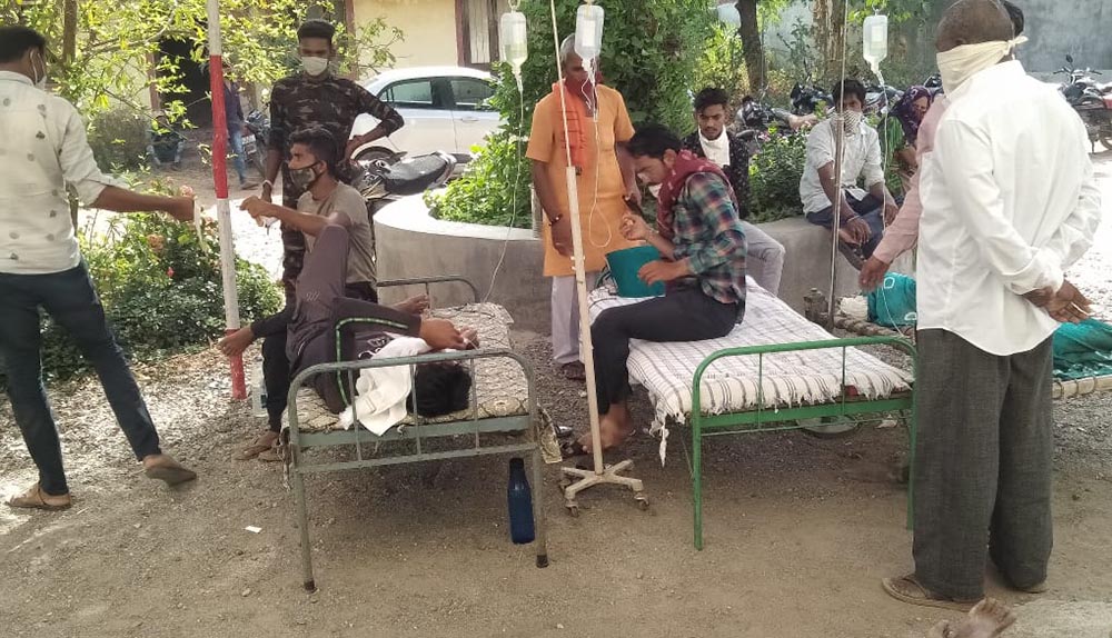 Villagers stay with their sick relatives under the shade of a tent erected on the campus of Jyoti clinic in Chachana village in the Rajkot Diocese in the western Indian state of Gujarat. (Courtesy of Chetan Parmar)