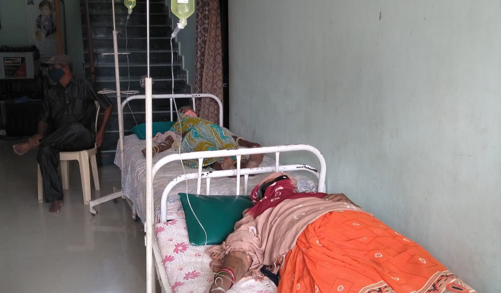 Patients who have tested positive for COVID-19 lie on two of the five beds inside Jyoti clinic, managed by Congregation of Mother Carmel nuns at Chachana village in the Indian state of Gujarat. (Courtesy of Chetan Parmar)
