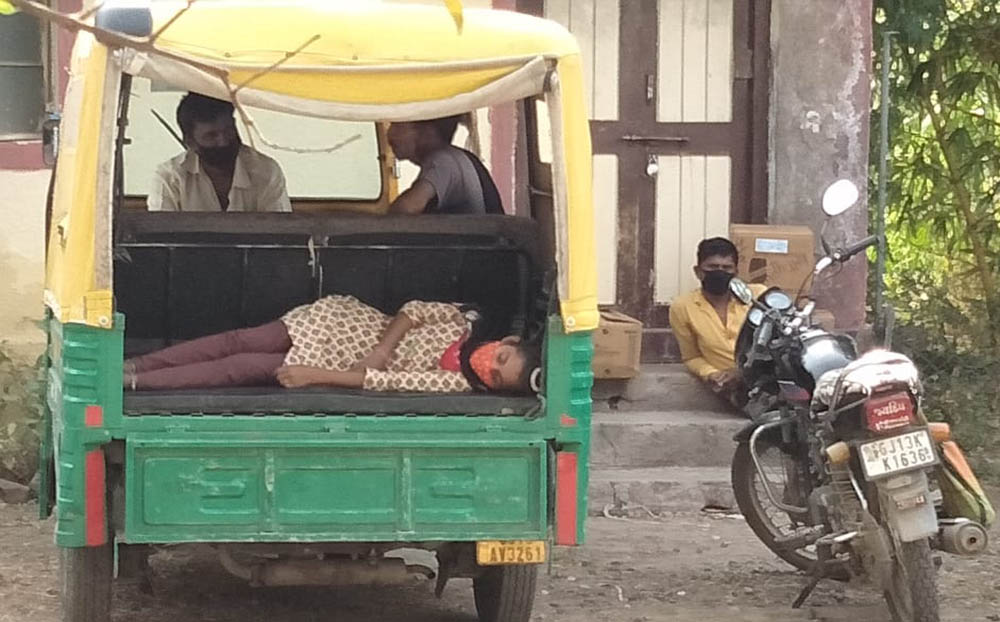 A young girl with COVID-19 symptoms is brought on a three-wheeler taxi to Jyoti clinic, managed by Congregation of Mother Carmel nuns at Chachana village in the Rajkot Diocese in the state of Gujarat. (Courtesy of Chetan Parmar)