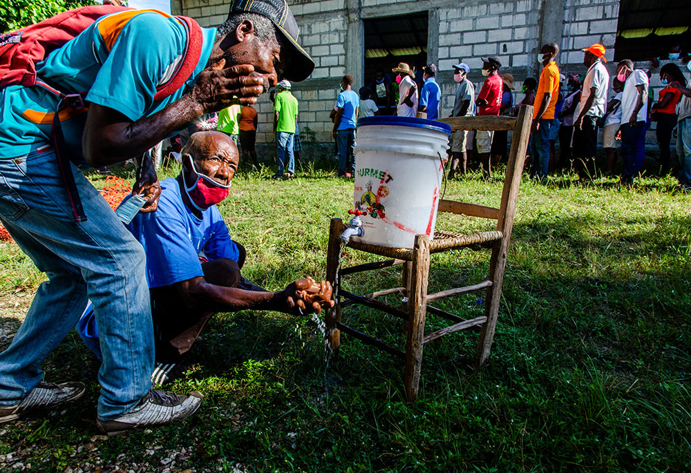 Haitians affected by the August 2021 earthquake in southern Haiti are seen in September at a Catholic Relief Services distribution site in the locality of Kay Raymond, Petit-Trou-de-Nippes, Haiti. (Catholic Relief Services/Georges Harry Rouzier) Haitians affected by the August 2021 earthquake in southern Haiti are seen in September at a Catholic Relief Services distribution site in the locality of Kay Raymond, Petit-Trou-de-Nippes, Haiti. (Catholic Relief Services/Georges Harry Rouzier)
