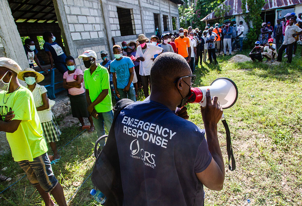 Haitians affected by the August 2021 earthquake in southern Haiti are seen in September at a Catholic Relief Services distribution site in the locality of Kay Raymond, Petit-Trou-de-Nippes, Haiti. (Catholic Relief Services/Georges Harry Rouzier)