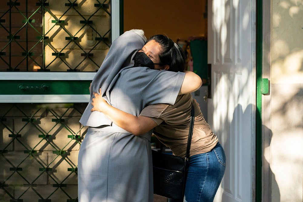 Sr. María San Martín hugs a student at the Virgin of Suyapa Center in Choloma, Honduras. (Gregg Brekke)