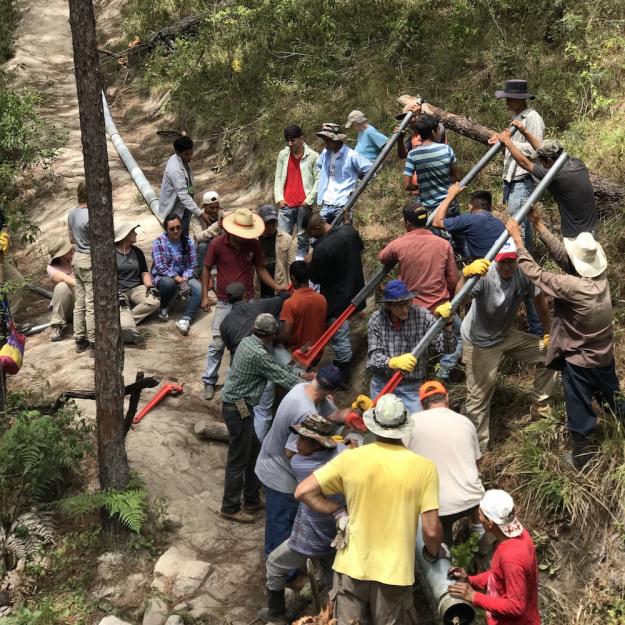 Sister Water Project volunteers install pipes to complete a 19-mile water project in the Honduran village of Mejocote, August 2018.