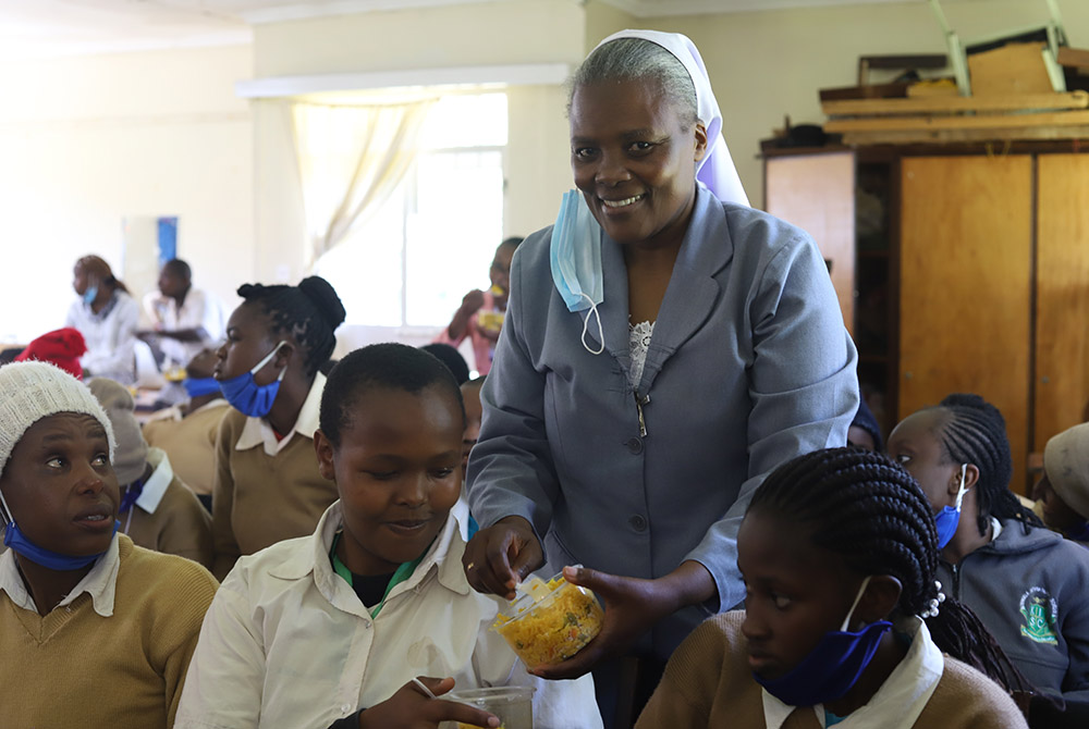 Sr. Rose Catherine Wakibiru of the Assumption Sisters of Nairobi distributes food to girls at Limuru Cheshire Home, a charitable institution for girls living with physical and intellectual disabilities in Kenya. (Wycliff Oundo)
