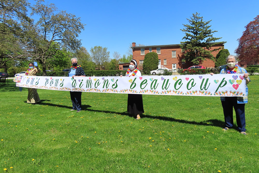 Sisters of Providence held a banner to let other sisters in the community who were isolated because of COVID-19 restrictions know they were appreciated and loved. The gesture was done several times throughout the pandemic, in rain as well as sun. (Courtes