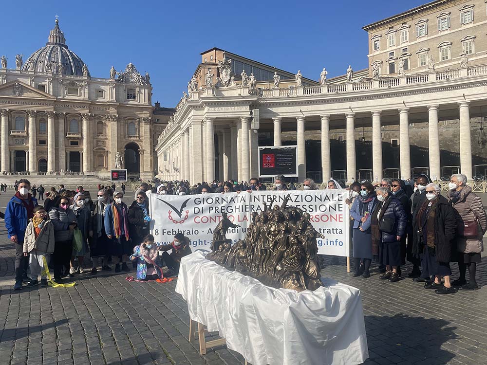 Catholic women religious and other anti-human-trafficking supporters gather with the model of "Let the Oppressed Go Free" at St. Peter's Square. Pope Francis offered his blessings to the sculpture, officially unveiled Feb. 6, and to the religious sisters 