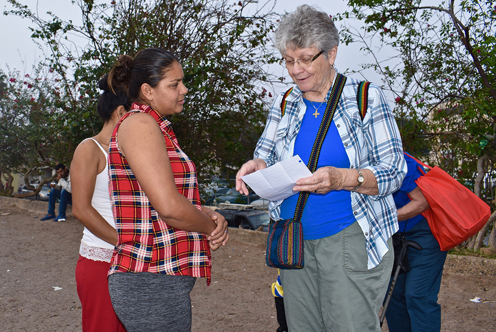 Notre Dame de Namur Sr. Mary Alice McCabe, right, welcomes a recently arrived Honduran mother to a migrant camp in Matamoros, Mexico, in 2019. (Courtesy of Mary Alice McCabe) Notre Dame de Namur Sr. Mary Alice McCabe, right, welcomes a recently arrived Honduran mother to a migrant camp in Matamoros, Mexico, in 2019. (Courtesy of Mary Alice McCabe)