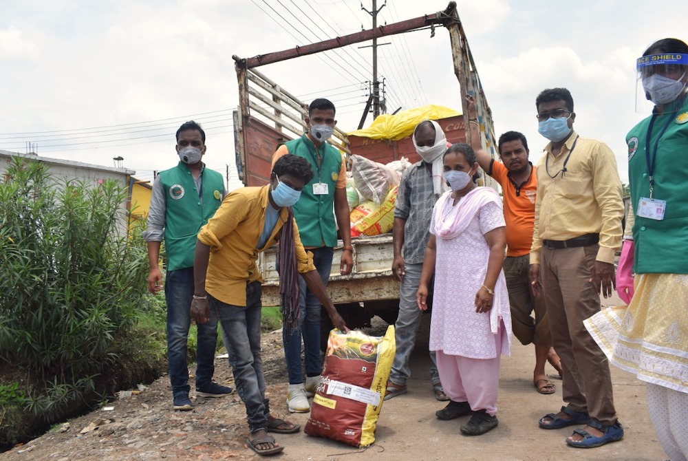 Sr. Clara Animottil, a member of the Sisters of St. Joseph of Chambery, distributes food to migrants in Itarsi, India. (Provided photo)