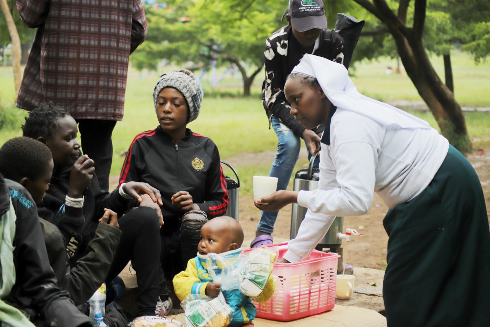 Sr. Caroline Ngatia shares breakfast with the street families in Nairobi, Kenya. The nun has been feeding the underprivileged children for years and, as a result, the kids simply call her "mum." (Doreen Ajiambo)
