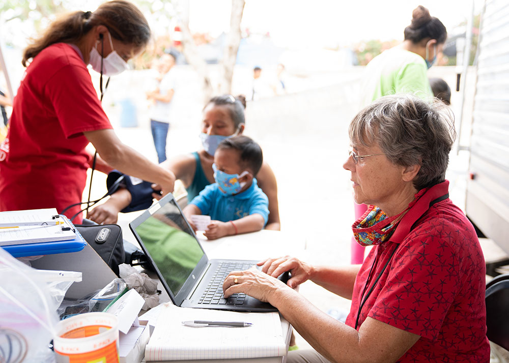 Ursuline Sr. Jacinta Powers at work at the migrant camp in Matamoros, Mexico (Courtesy of Lexie Harrison-Cripps)