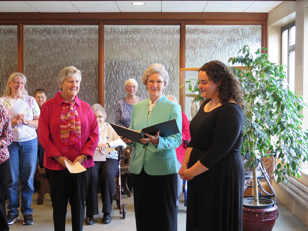Sr. Anne Wambach, in the green jacket, and Jacqueline Small, right, at Small's April 28, 2019, postulant ceremony at the entrance to the Benedictine Sisters of Erie's monastery in Erie, Pennsylvania (Courtesy of the Benedictine Sisters of Erie)