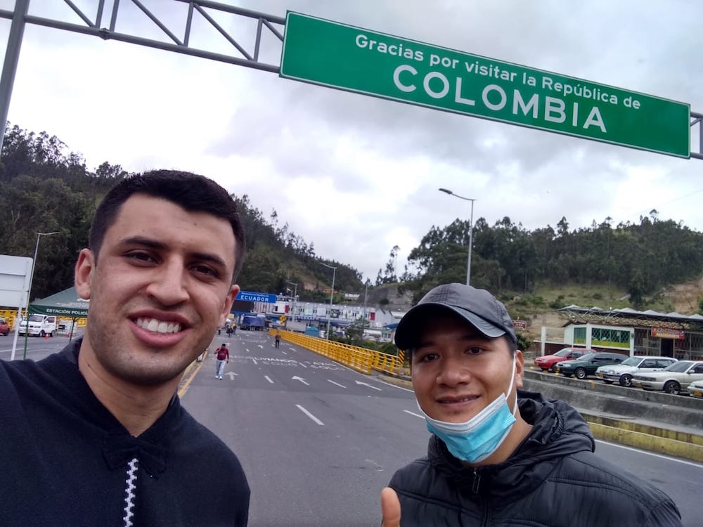 Juan Pablo Navarro, at left, is seen with fellow Scalabrinian missionary Tien Nguyen Van at the Colombia-Ecuador border in Ipales, Colombia. Migrants from Venezuela pass through Colombia to Ecuador on their way to Peru or Chile. (Provided photo)
