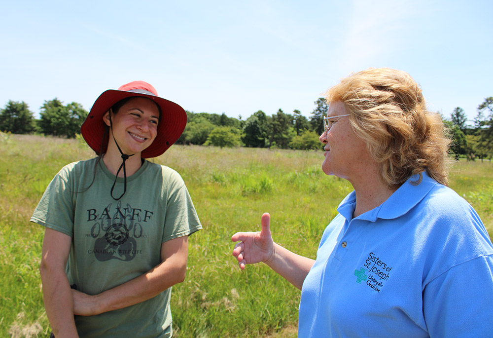 Sr. Karen Burke, the coordinator of land initiatives for the Sisters of St. Joseph, Brentwood, right, speaks to Amanda Furcall, the campus' landscape ecologist. (GSR photo/Chris Herlinger)