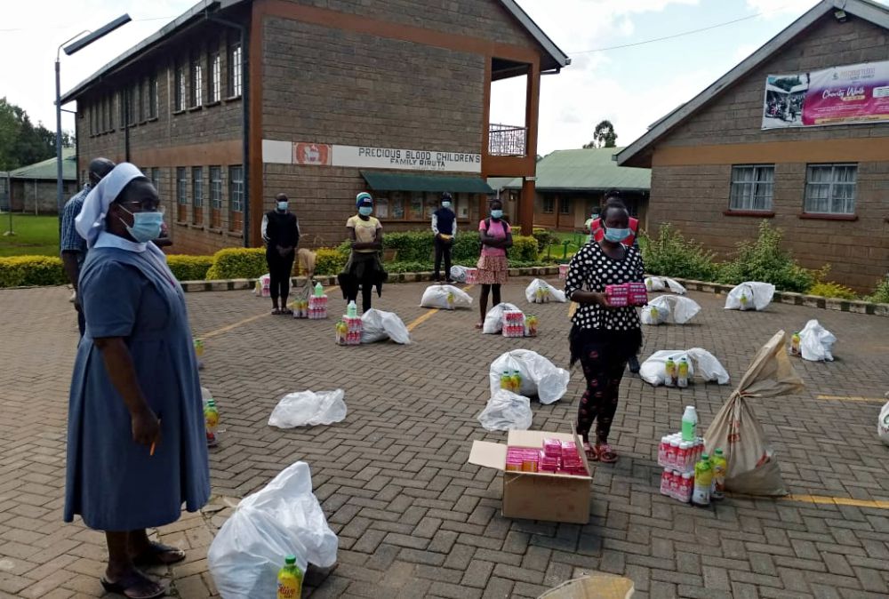 Sr. Ann Grace Njau of the Missionary Sisters of the Precious Blood distributes sanitary pads and other essentials to girls from Amani Rehab and Primary School in Nairobi. (Provided photo)