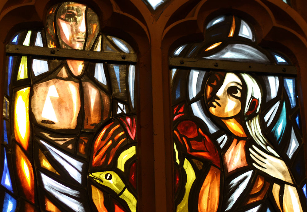 Adam and Eve depicted in stained glass in St. Heribert Catholic Church in Kreuzau, Germany (Wikimedia Commons/Reinhardhauke)