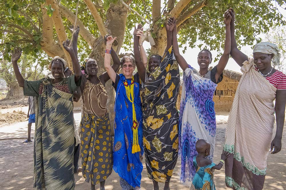 Mercy Sr. Marilyn Lacey of Mercy Beyond Borders with South Sudanese refugee women of various ethnic groups in Boroli Refugee Camp, Adjumani, Uganda.