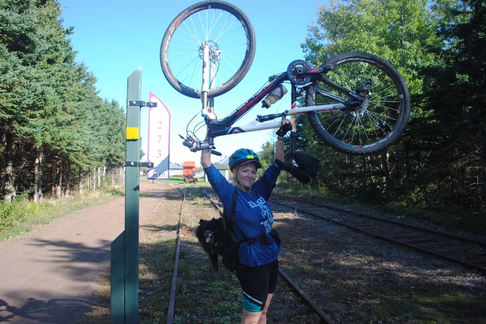 Sr. Libby Osgood of the Congrégation de Notre-Dame celebrates the end of a three-day, 160-mile ride across Prince Edward Island, Canada. (Courtesy of Cycling With Sisters)