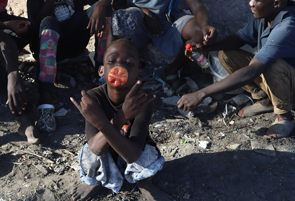 A child sniffs toxic glue from a plastic bottle on the streets of Mombasa, a coastal city in southeastern Kenya on the Indian Ocean. The high rate of youths using drugs has visibly affected their lives and the safety of the region. (GSR photo)