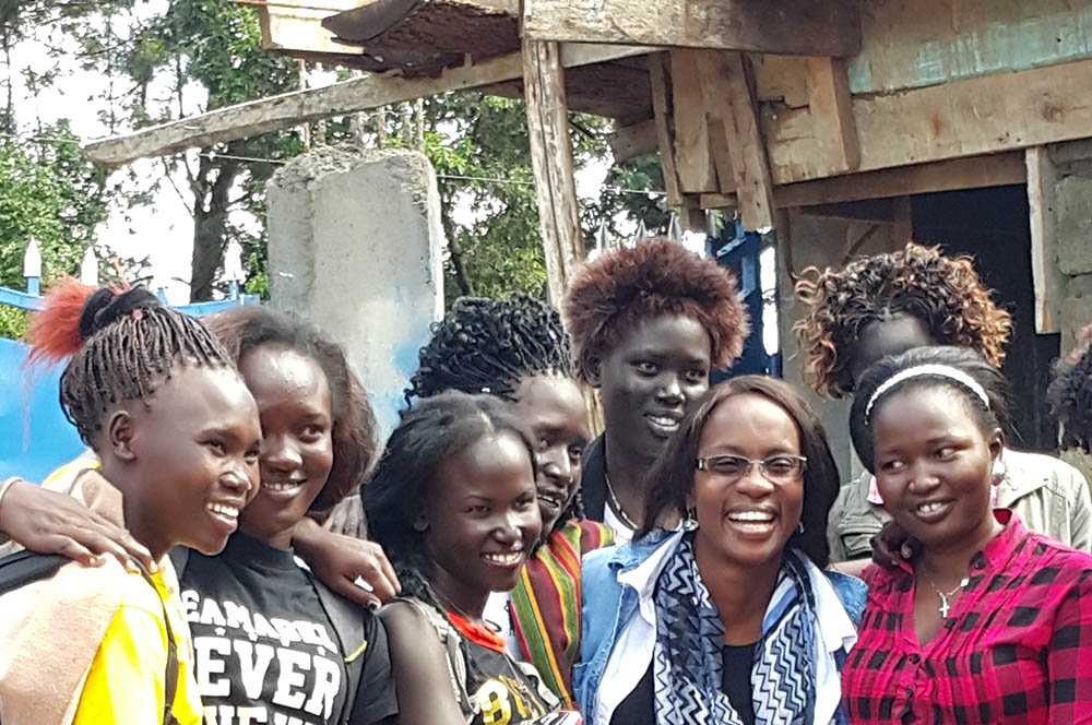 Shown here with scholars at a University Scholars Program leadership training is Teresa Samuel-Boko, in blue, a Mercy Beyond Borders board member from South Sudan. 