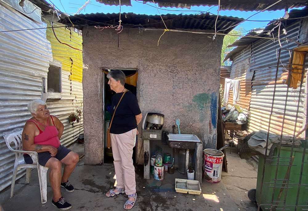 Passionist Sr. María Angélica Agorta visits with a woman in her home in Villa Hidalgo, Buenos Aires, Argentina. (GSR photo/Soli Salgado)