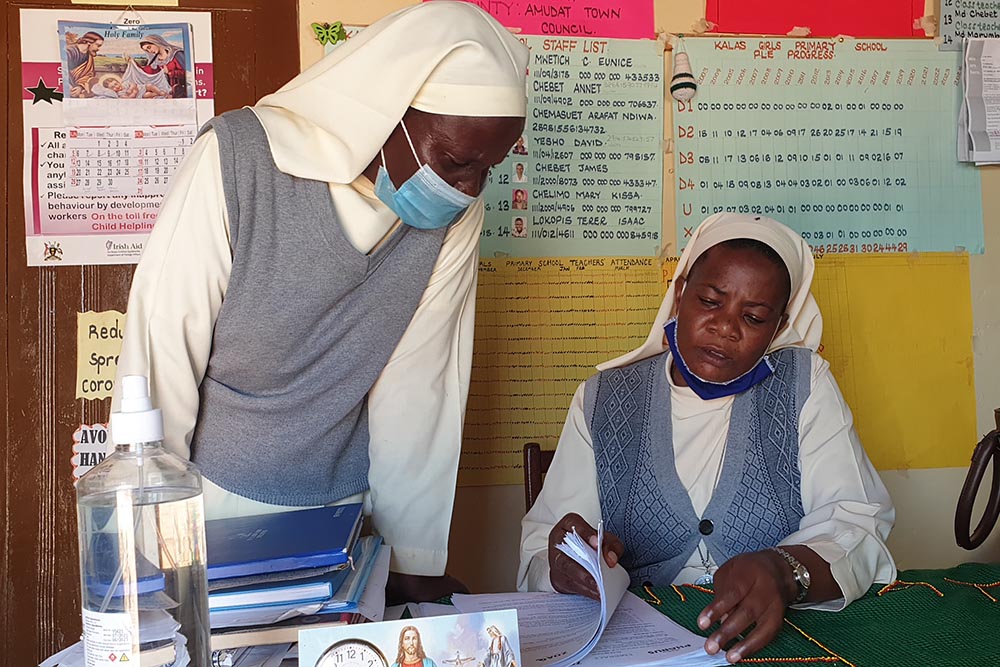 Sr. Maria Proscovia Nantege, right, a member of the Sisters of the Immaculate Heart of Mary Reparatrix-Ggogonya and headmistress of Kalas Girls Primary School in Amudat, northern Uganda, talks to Sr. Dorothy Sserabidde at Nantege's office at the school.