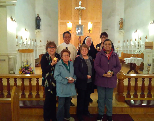 St. Joseph Sr. Mary Christine Taylor, center of the back row, with Fr. Jerome Pastores and new eucharistic ministers in the sanctuary of St. Regis Catholic Church Mission in Quebec in 2019 (Provided photo)