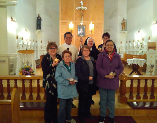 St. Joseph Sr. Mary Christine Taylor, center of the back row, with Fr. Jerome Pastores and new eucharistic ministers in the sanctuary of St. Regis Catholic Church Mission in Quebec in 2019 (Provided photo) St. Joseph Sr. Mary Christine Taylor, center of the back row, with Fr. Jerome Pastores and new eucharistic ministers in the sanctuary of St. Regis Catholic Church Mission in Quebec in 2019 (Provided photo)