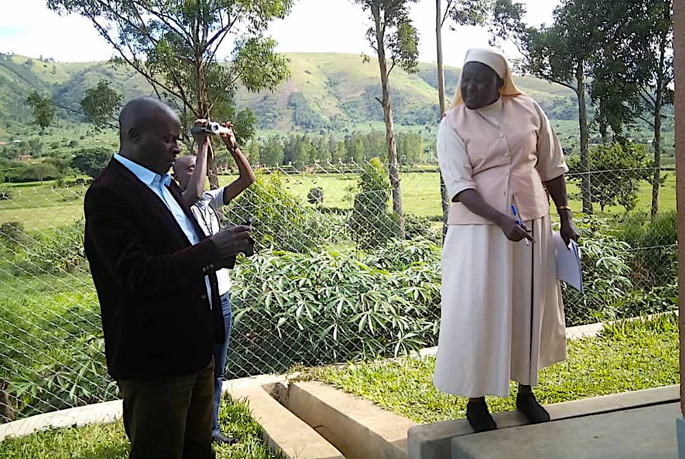 Sr. Mary Grace Akiror, right, points out some detail while inspecting government projects in western Uganda. (Gerald Matembu)