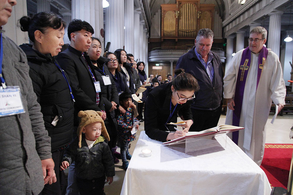 Members of the Chinese community at the 2018 Rite of Election in St. Mary's Pro-Cathedral in Dublin with Fr. Damian McNeice, right, of the Dublin Archdiocese's Liturgical Resource Centre (Courtesy of John McElroy)
