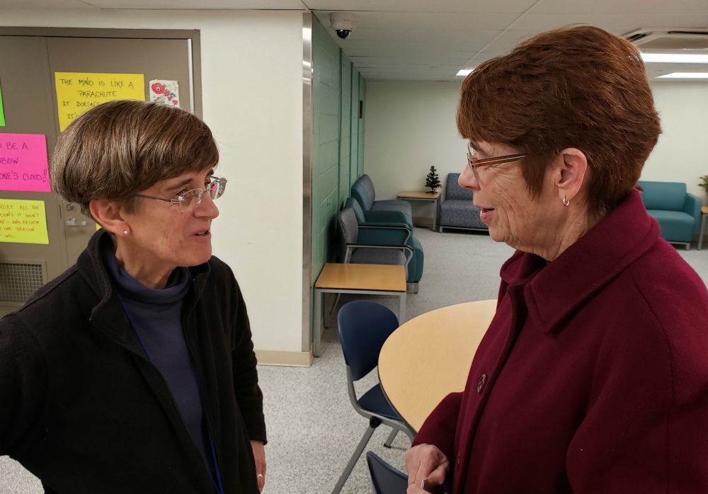 Mercy Sr. Mary Scullion, right, meets with fellow Mercy Sr. Eileen Sizer in December at the Hub of Hope, a safe space for those experiencing homelessness, in Suburban Station in downtown Philadelphia. (GSR photo/Chris Herlinger)