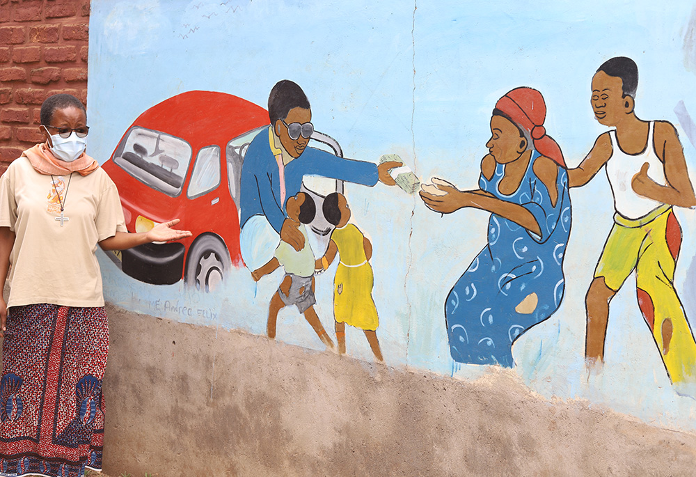 Sr. Anna Masawe explains an image in which parents are shown selling their children due to the poverty that has engulfed Malawi. (GSR photo/Doreen Ajiambo) Sr. Anna Masawe explains an image in which parents are shown selling their children due to the poverty that has engulfed Malawi. (GSR photo/Doreen Ajiambo)