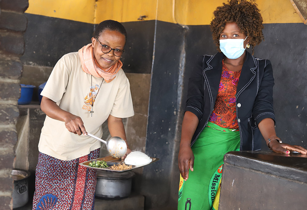 Sr. Anna Masawe serves food to a staff member at the Tikondane care center. (GSR photo/Doreen Ajiambo)
