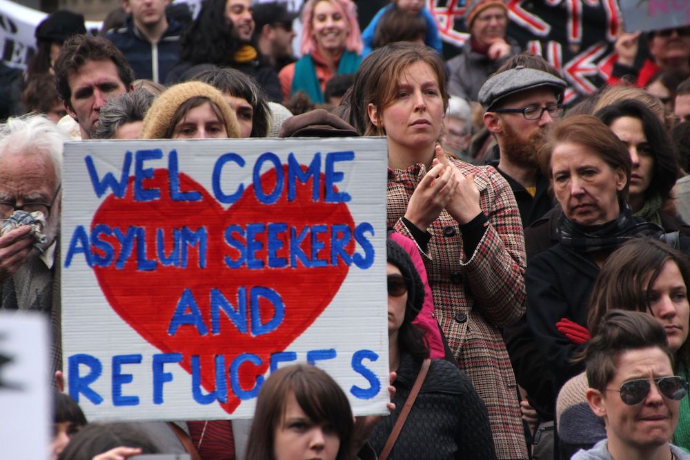 People at a Melbourne refugee and asylum seeker rights rally July 27, 2013, protest both the Rudd Labor Government new proposal for assessment and resettlement of asylum seekers in Papua New Guinea, and the Liberal Party's hard line stand to use the milit