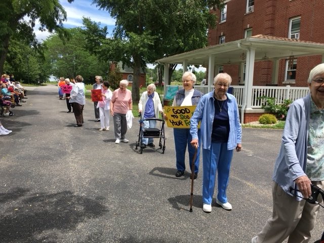 Dominican Sisters of Peace and residents of the congregation's Sansbury Care Center in St. Catharine, Kentucky, enjoy a parade put on for the residents in June 2020. Residents had been socially isolated for months due to the pandemic, and the socially dis