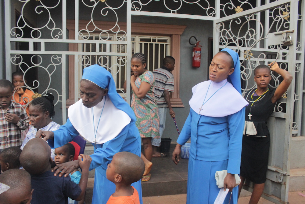 Sr. Elizabeth Nwankwo, left, and Sr. Veritas Onyemelukwe direct children in the charity home they run with another Daughter of Divine Love during an afternoon class they started when the lockdown was announced. (Patrick Egwu)