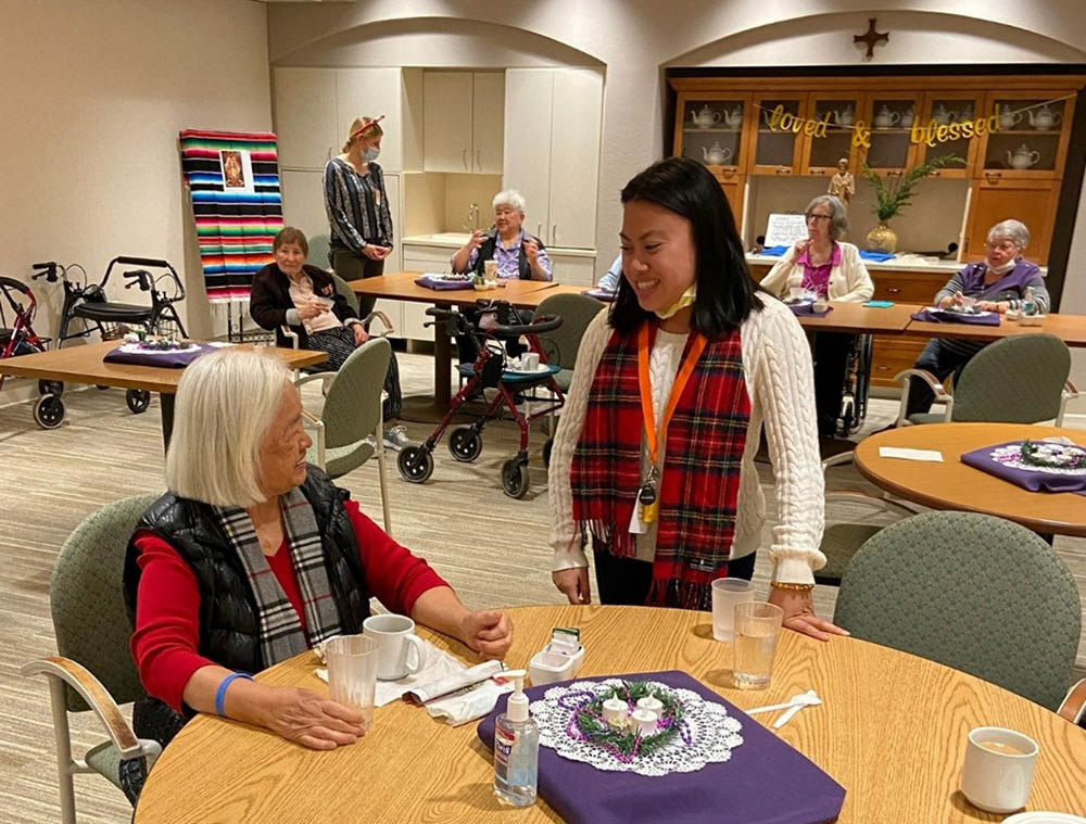 Sr. Mariquita Domingo tells me about her ministry and calling to religious life at the Regina Residence Christmas party. (Courtesy of the Sisters of St. Joseph of Orange)