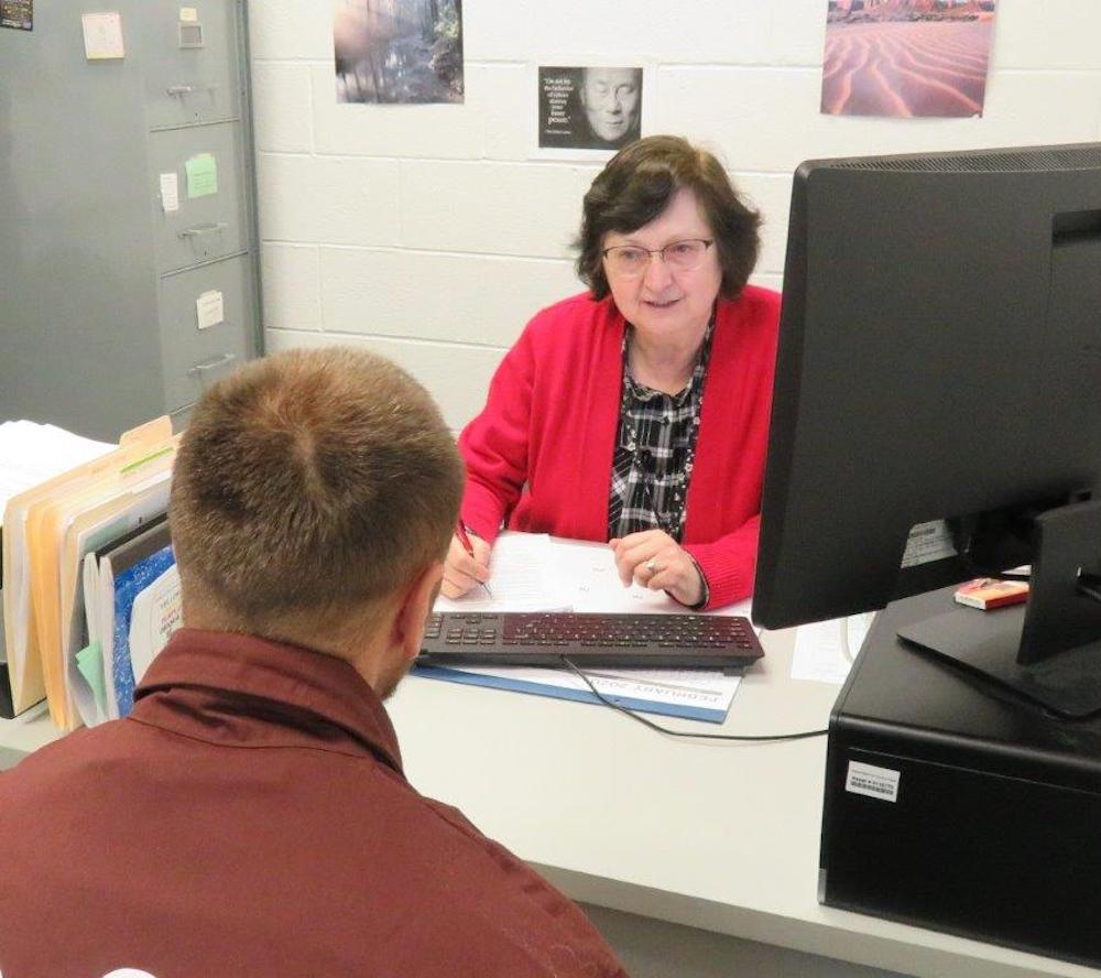 Benedictine Sr. Sue Fazzini speaks with inmate in her office at the Pennsylvania State Correctional Institution Greene in Waynesburg, southwest Pennsylvania. Fazzini heads the drug and alcohol treatment program at the prison. (Courtesy of the Pennsylvania