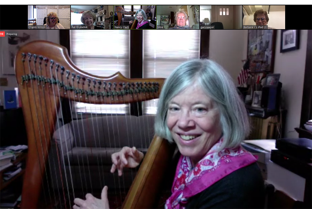 Nancy Bick Clark, an associate with the Sisters of Charity of Cincinnati, Ohio, plays the harp during a Zoom commitment ceremony in March 2020 for new associate Jean Simpson. (Courtesy of the Sisters of Charity of Cincinnati)