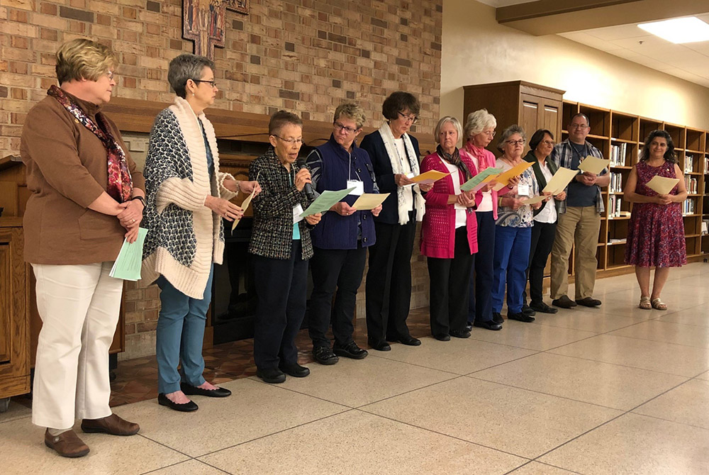 Eleven cojourners of the Sisters of St. Francis of Rochester, Minnesota, renew their covenant in October 2019 in front of an audience of other cojourners, family members and sisters. (Courtesy of the Rochester Franciscans)