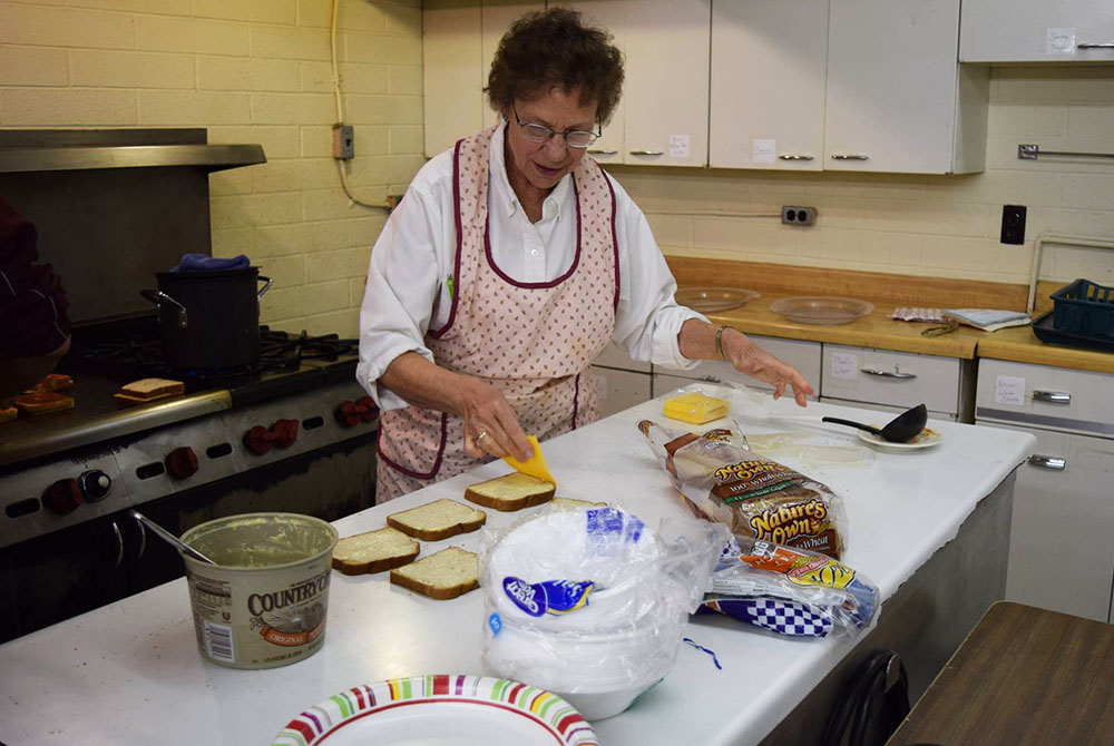 Sr. Patricia Bietsch prepares grilled cheese sandwiches in the St. Mary Mission hall kitchen, February 2016 in Tohatchi, New Mexico. (Julie A. Ferraro)