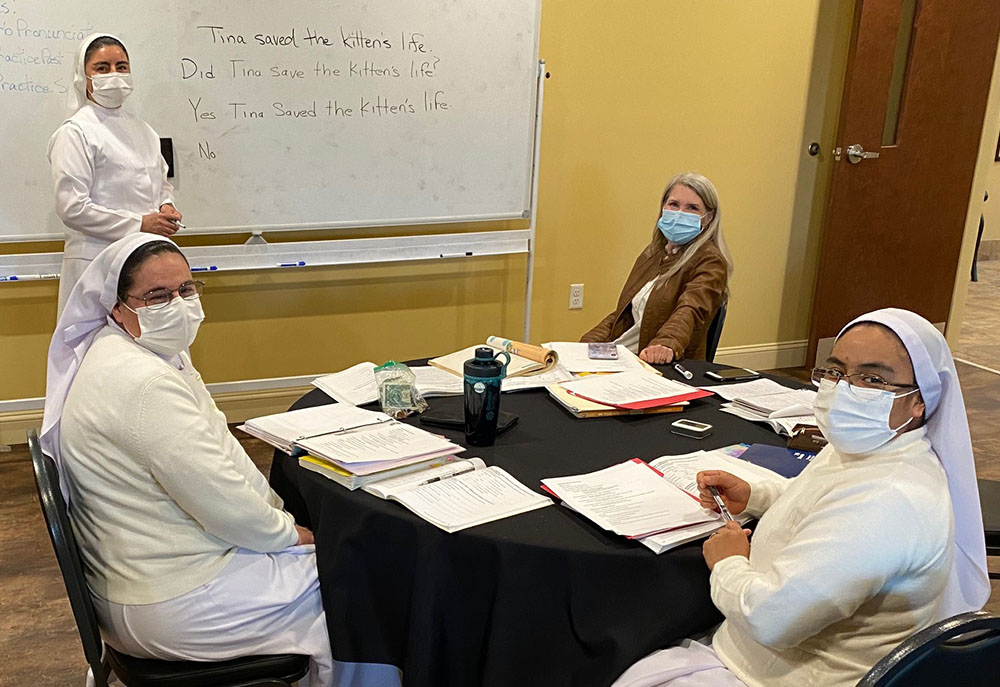 From left: Sr. Ignacia García Ramos, Sr. Guadalupe Martínez Castillo, instructor Kim Campbell, and Sr. Felipa Santos Tapia in a March class in English as a second language at Centro de San Juan Diego in Lexington, Kentucky. (Courtesy of Jim Bennett)