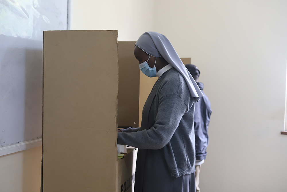 A religious sister marks her paper ballot in a voting booth Aug. 9 at a polling station at the Karen Kenya Medical Training College in Nairobi, Kenya. (GSR photo/Doreen Ajiambo)